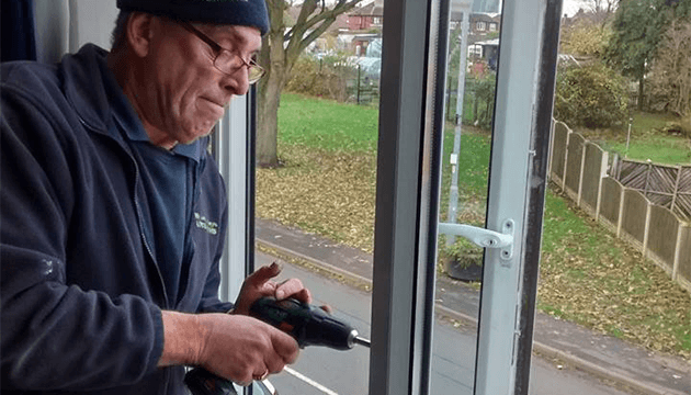 Locksmith Martin Working on a upvc WIndow